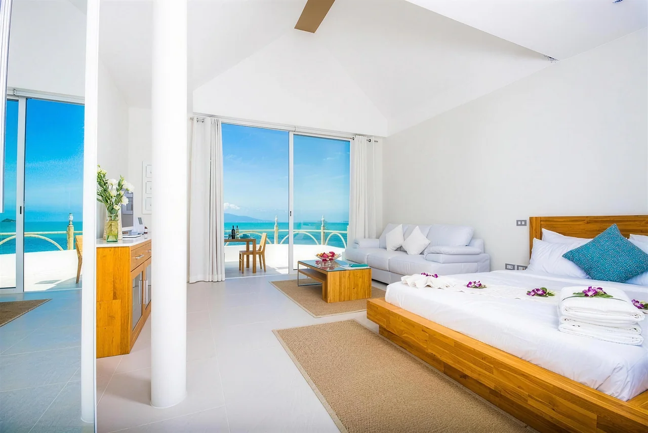 An upper suite with vaulted ceilings opening to the sea