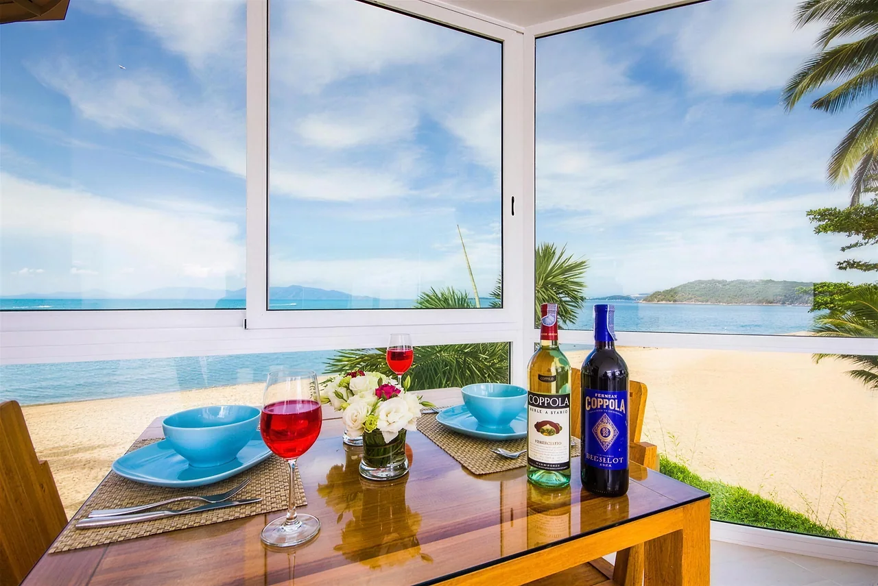 The dining table set with the beach beyond